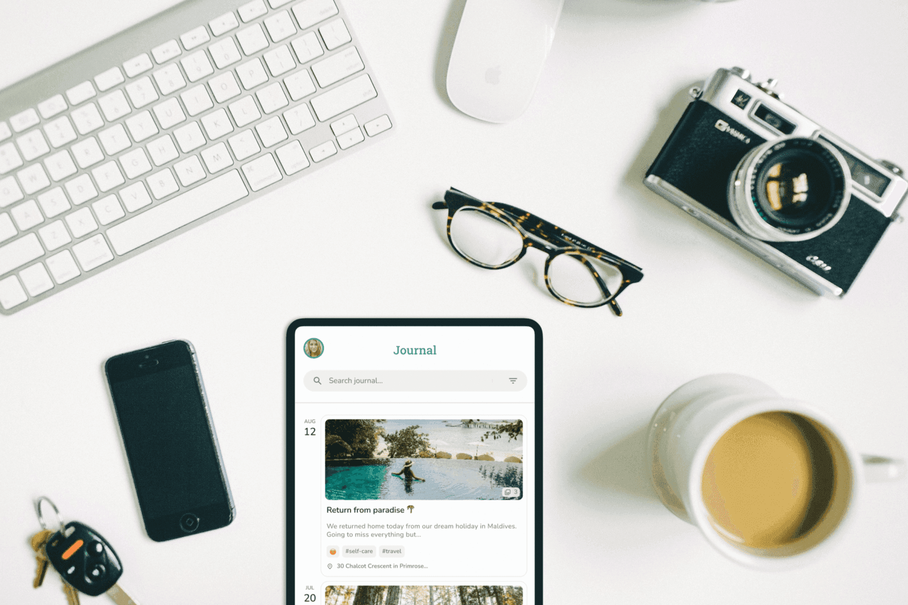 Desk photo with a tablet showing the journal timeline view